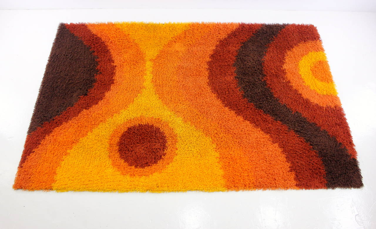 Vividly colored rya rug.
6' x 9' of maximum impact.
Undulating pattern of lush brown, rust, orange and marigold.
Deep, rich nap.