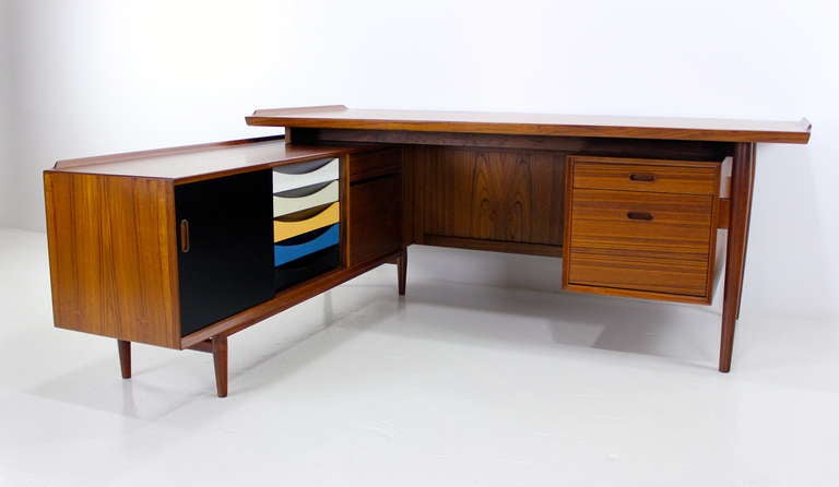 Impressive danish modern teak desk and return.  Designed by Arne Vodder. Sibast, maker.  Desk features two drawers on top right including top drawer with divided tray and bottom file drawer.  Signature Vodder raised lip on each end.  Repositionable