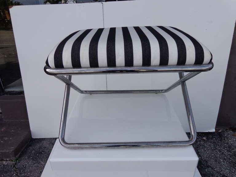 Tubular chrome x bench with cabana black and white stripe fabric.