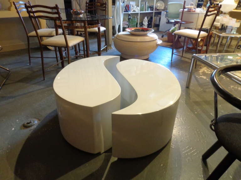 Two piece table with chrome banding on base forming a Yin Yang design.  One table being 1 inch higher than the other.  Recently lacquered in white with a polished chrome base.
