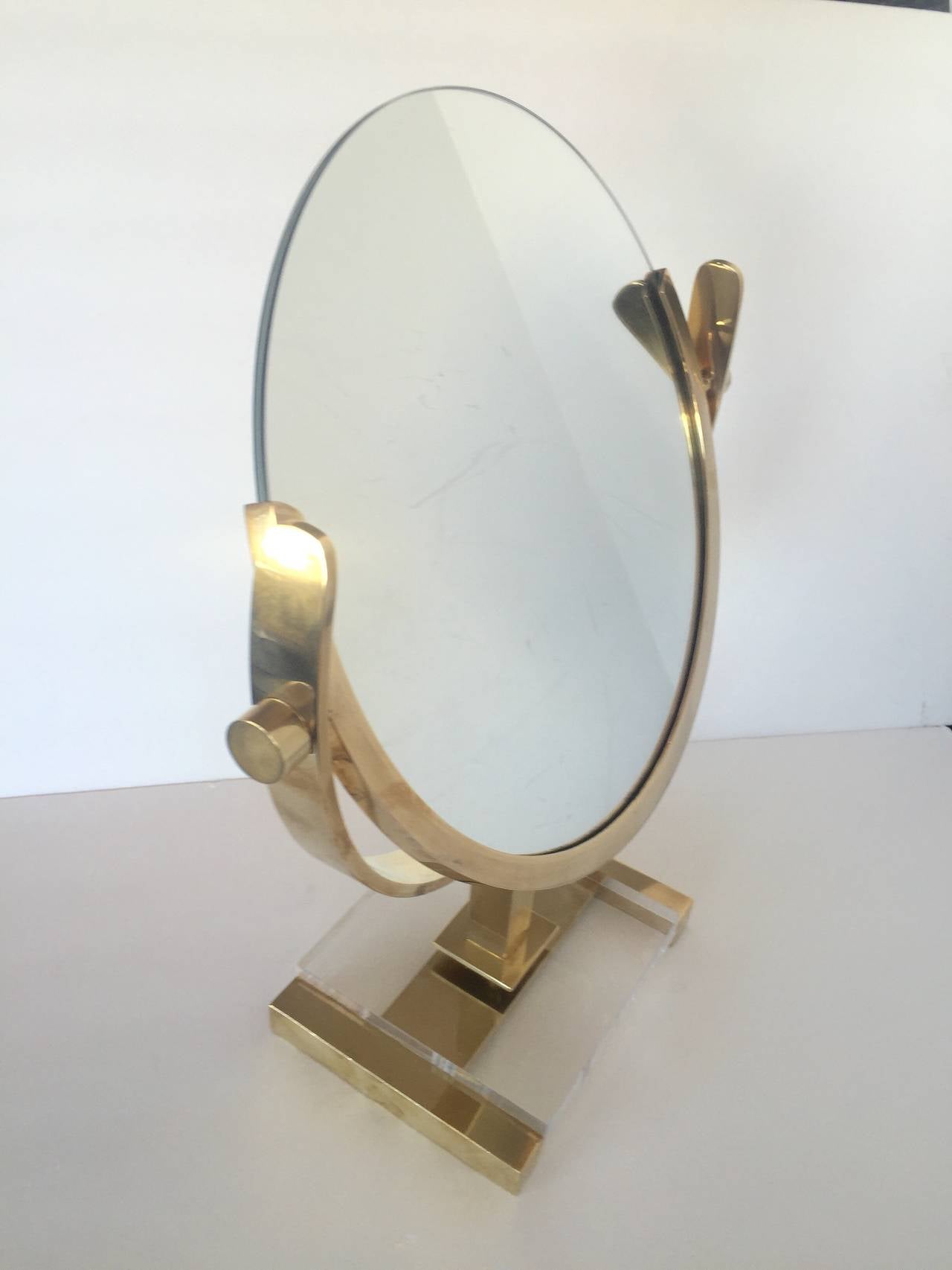 Stunning pivoting table mirror in brass and Lucite. Well made with great detail. Recently polished.