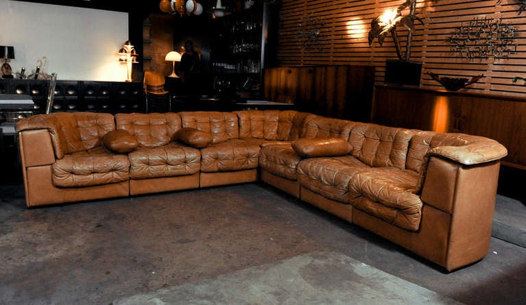 Stunning 7 pieces modular sofa model ds-11 by Swiss top level brand De Sede. The sofa is upholstered in a soft and smooth light tanned brown patchwork leather. There are 3 corners and 4 straight pieces, so there are numerous ways to put it, even a