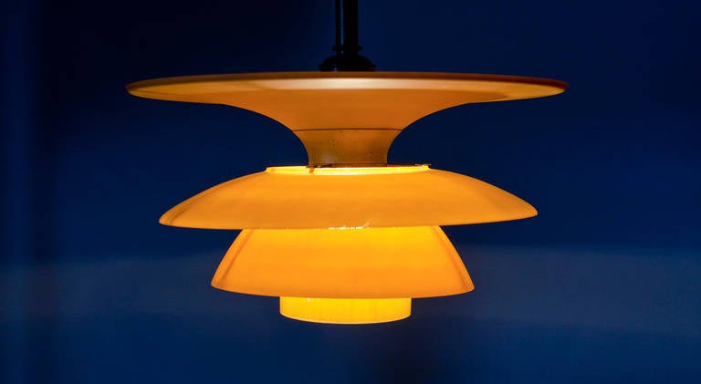 Poul Henningsen. Four-Shade Lamp with 4/4, 5/4 yellow matt glass shade set.
Browned brass socket cover and canopy.
Produced by Louis Poulsen. Ø 43 cm. 
The Four-Shade Lamp was deverloped 1929-31 and introduced in 1931.
Literature: Jørstia et