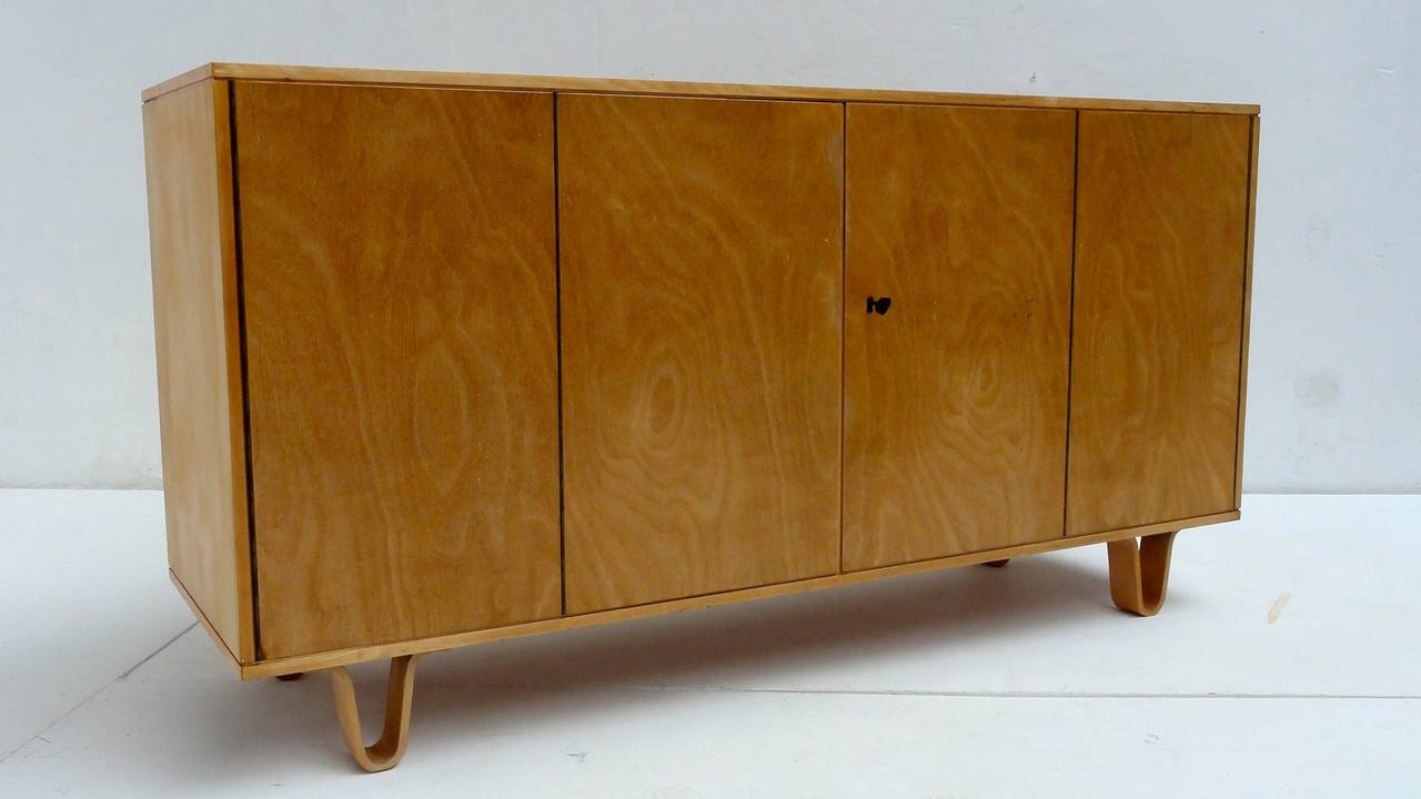 Credenza, model DB02, designed by Cees Braakman
Manufactured by UMS Pastoe The Netherlands around 1955

The 2 double folding doors conceal 4 drawer units and a small unit on the right side and a big unit on the left side
The credenza is