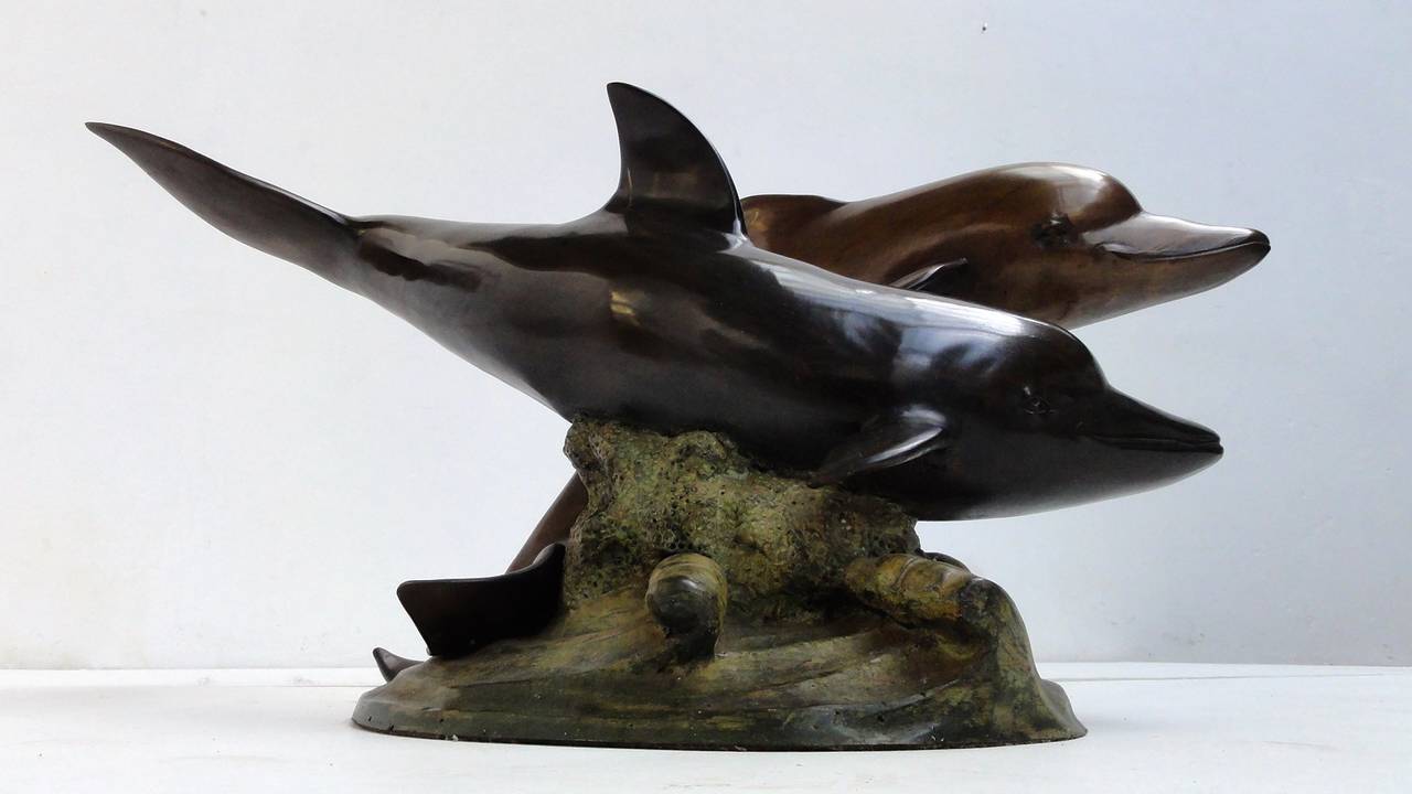 A very decorative casted bronze coffee table figuring 2 swimming dolphins

If you are a big fan of Flipper this is a must have piece!