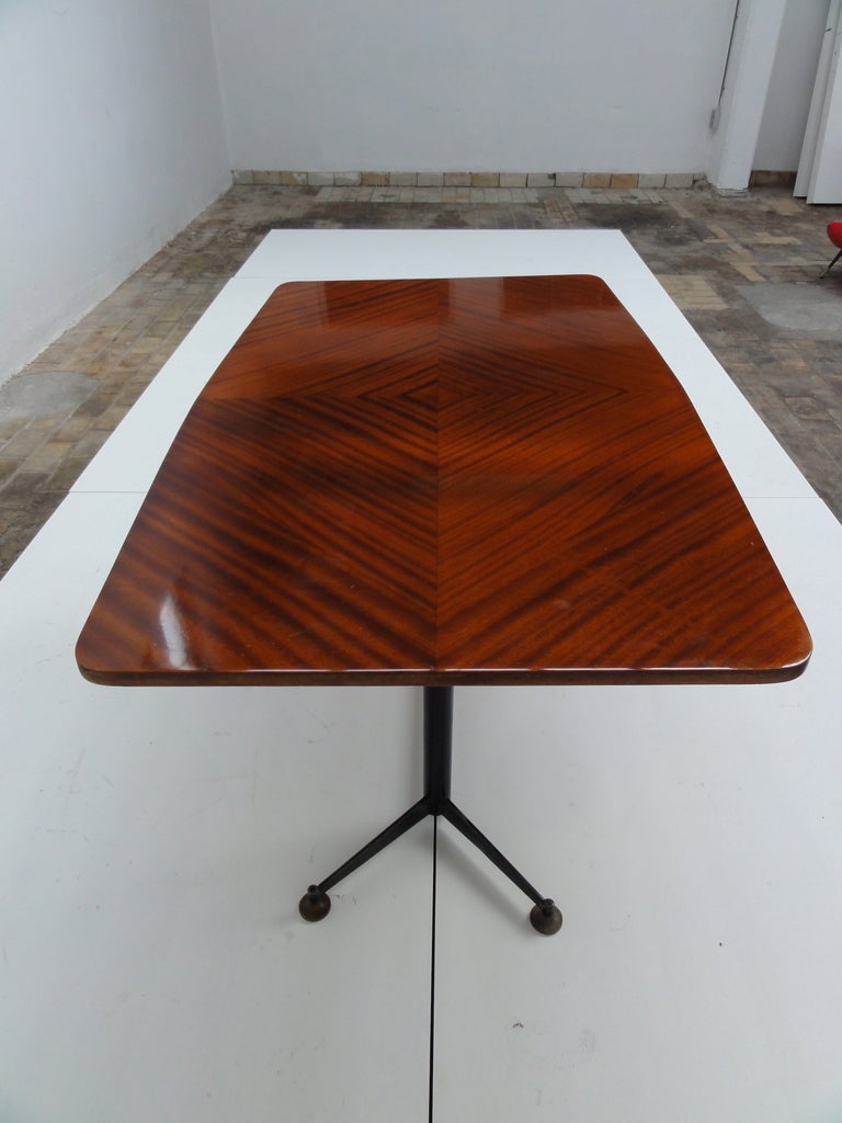 A superb  writing table  / desk finished in stunning tulipwood by iconic  italian  architect Ignazio Gardella (1905-1999).
The supporting base is made of enamelled metal with adjustable feet  made of  bronze.

Gardella was  particularly  well