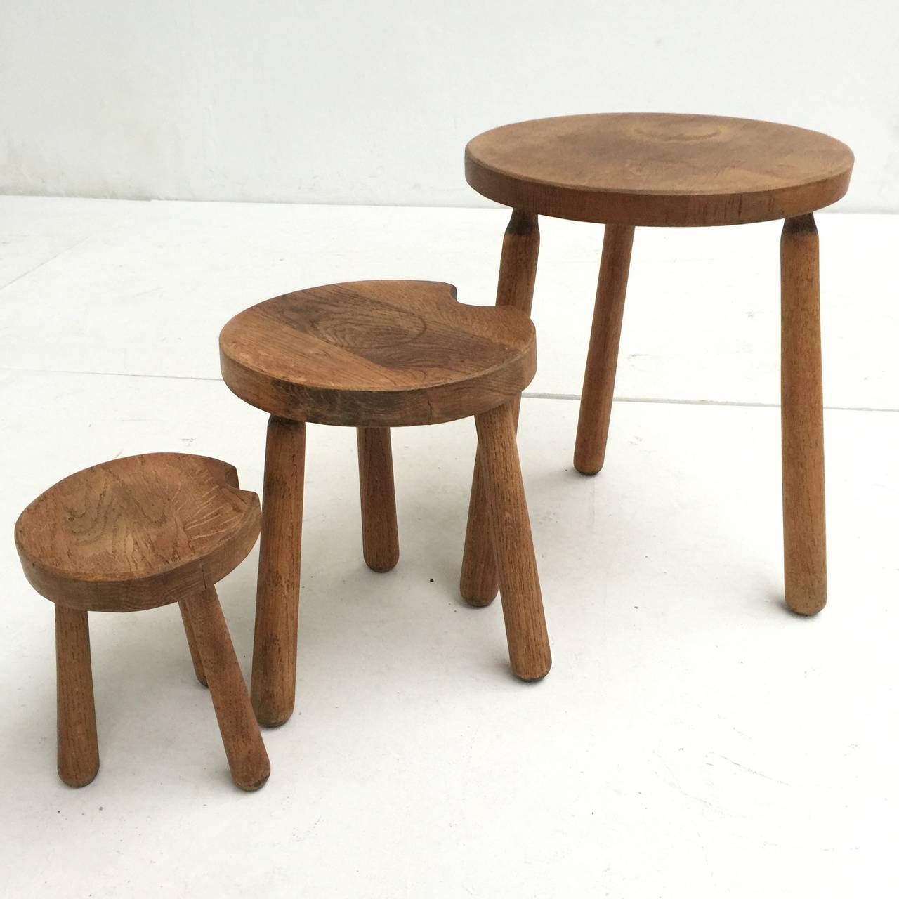 A lovely set of rustic oak nesting tables in the Alpine style of Charlotte Perriand

They 2 smaller tables have a cutout in the top so you can compose them in many nice compositions as shown in pictures

The size listed is that of the largest