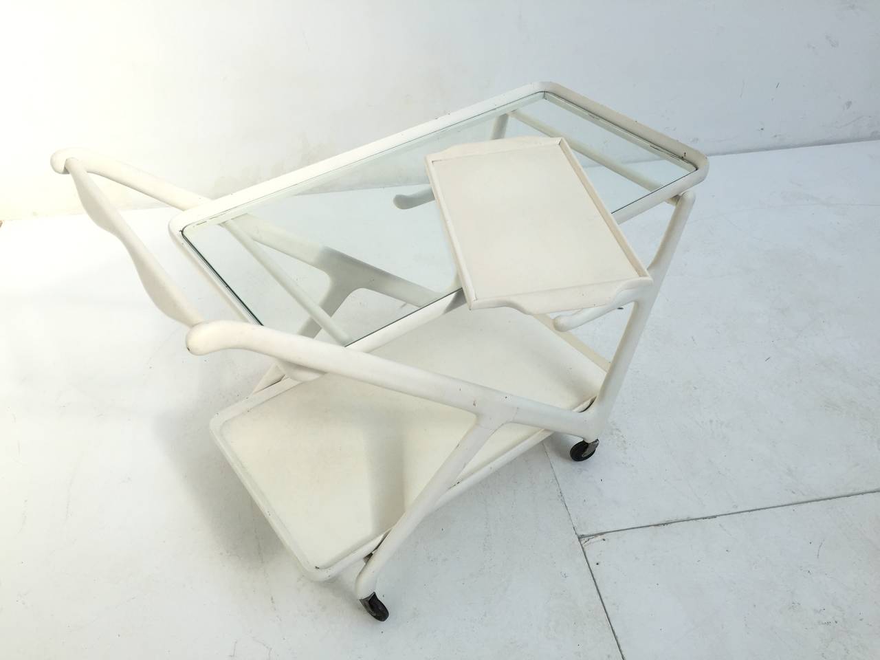 Unique white lacquered tea trolley or bar cart by Cesare Lacca for Cassina

In my opinion the white lacquer is period correct from when it was produced, or it has once been repainted but it has been done professionally 

An eye catching piece