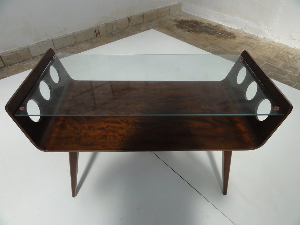 Rare and hard to find vintage plywood coffee table by Dutch designer Wilhelm Lutjens from the 1950s. With wonderful moulded plywood curved tray, circular cut out design and glass top, this table has an interesting yet elegantly simple design.
