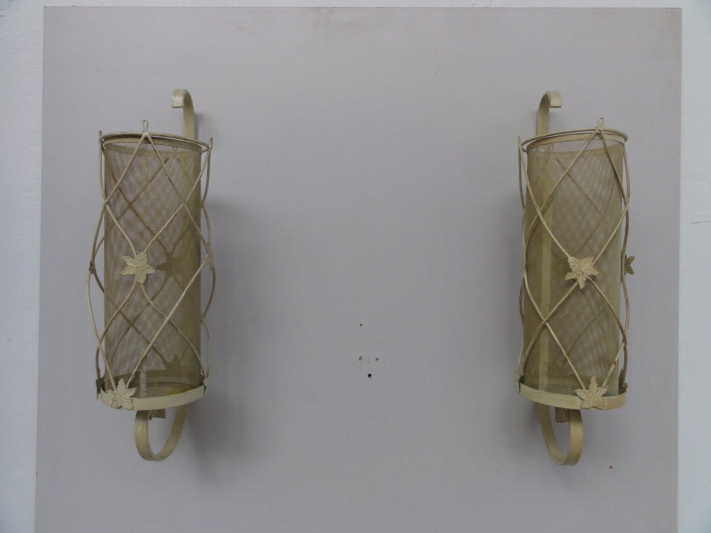 A decorative pair of wallmounted French candle holders in the style of Jean Royere
Perforated metal with Ivy leave decoration