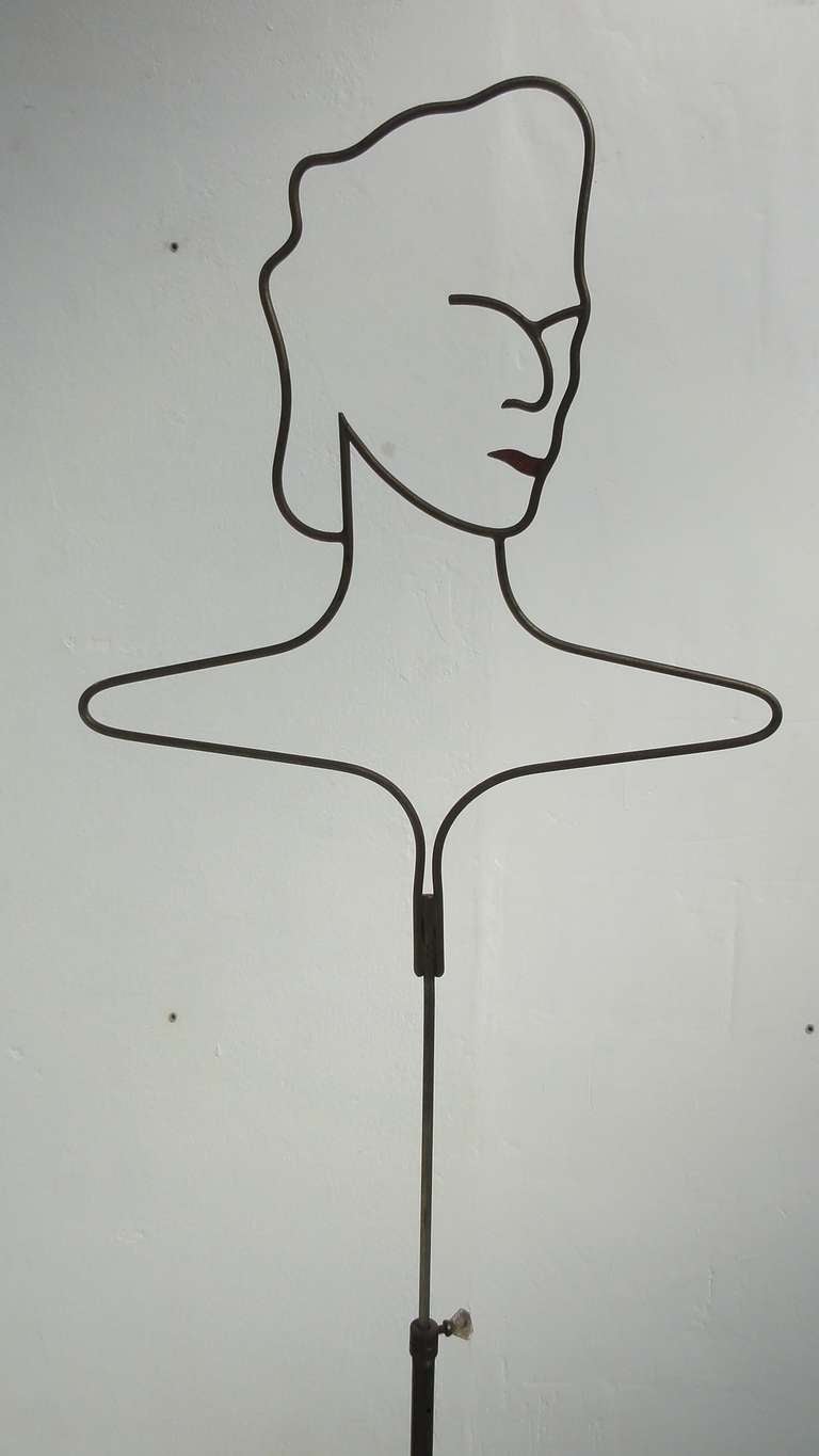 Nice detailed 1950s wire mannequin

Metal wire and brass tripod feet, red enameled lips as a detail

Measures: Adjustable in height highest 68