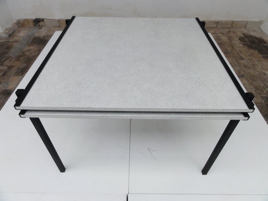 This extendable dining table is clearly Influenced by the Military table (Gerrit Rietveld) and the works of Piet Mondriaan.
2 seperate tops can be pulled out the metal frame to adjust the table size.
