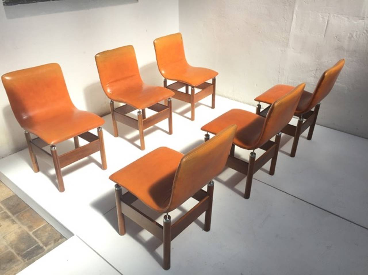 Wonderful set of six 'Chelsea' dining chairs by Vittorio Introini in the very rare original leather and solid walnut finish specification. The 'Chelsea' chair was designed in 1966 for the progressive design company Saporiti.

The seats are