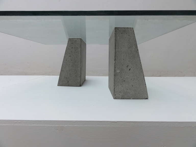 A minimal but also brutalist coffee table produced in the 1970's.

The pure forms of the concrete base give this table a very nice appeal and will make it a perfect fit for any minimal interior.

