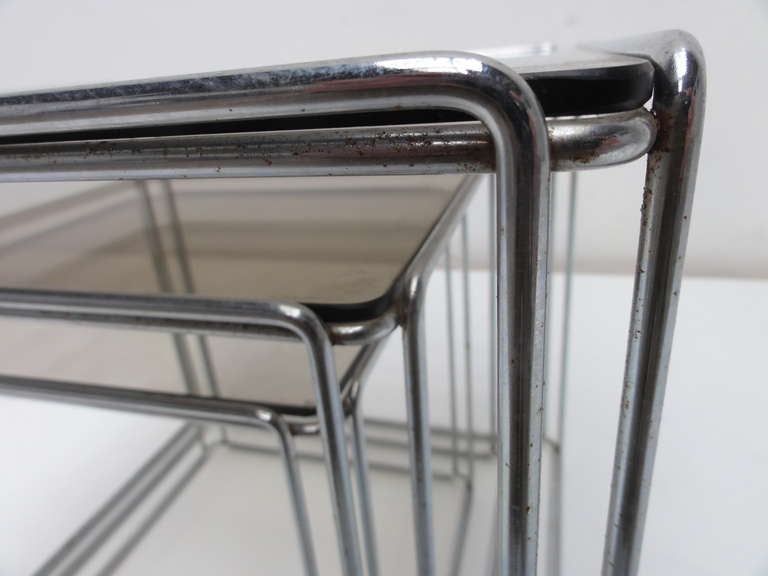 Rare complete set of three nesting tables designed by French artist Max Sauze  and produced by Groupe S.A France,circa 1970.
The structure is  made of chromed steel rod and all tables retain their original smoked glass.