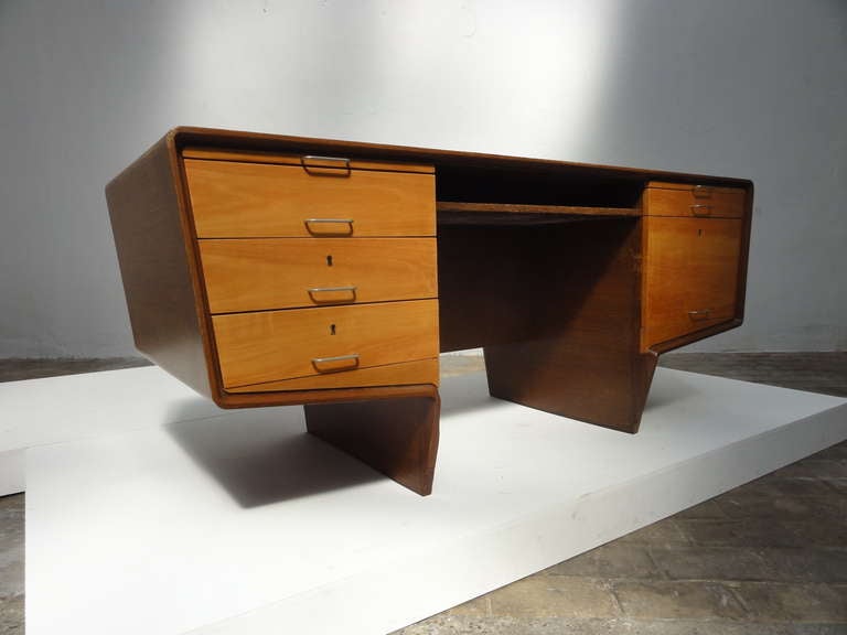 A very special custom ordered executive desk from the 1960's.

The complete exterior has been done in Wenge wood with beechwood drawers and a white skai leather back.

This desk comes from the executive's office of a Psychiatric institute in