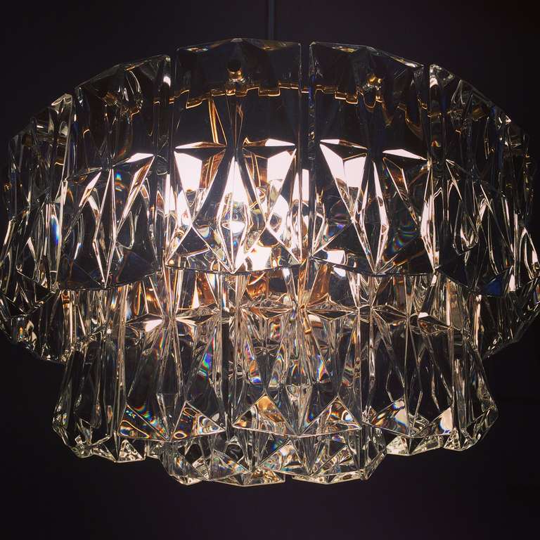 A rare brass version of a 3 trier Kinkeldey chandelier composed of 34 deep cut rectangular shaped crystal prisms.

There are 2 extra brass rods to extend the lamp to a height of 131.5cm/51.77inch

The prisms measure 14.5cm/5.7 inch x