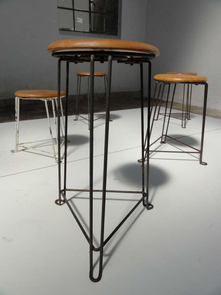 Tomado was founded in Holland in 1923 and boomed in the 1950's.
They offered a wide range of household products that sold well all over Europe.

One of their 50's designs are these stools with a nice metal wire construction base and birchwood