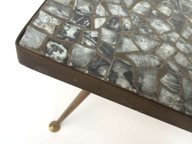 Handsome German production 1950s coffee table with brass legs and mosaic glass top in various tones of white grey and black.<br />
<br />
The brass is nicely aged and patinated to maintain the original vintage character<br />
 (can be polished to