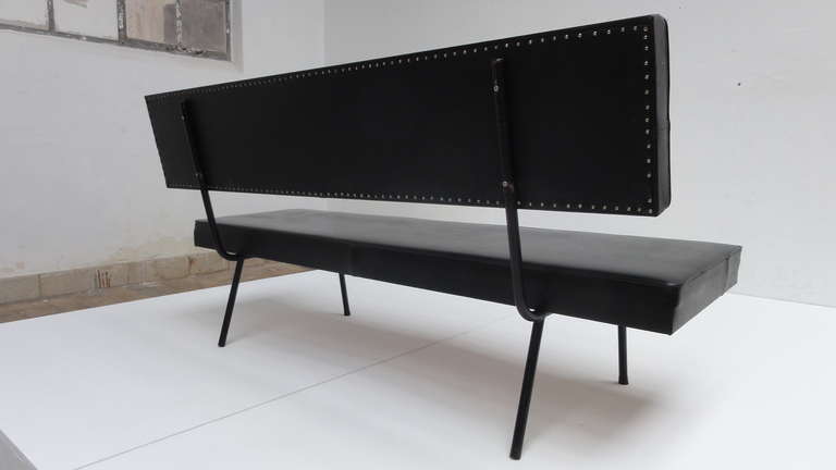 A minimal design bench in the manner of Wim Rietveld.

The bench still has it's original black skai leather upholstery from the 1950's