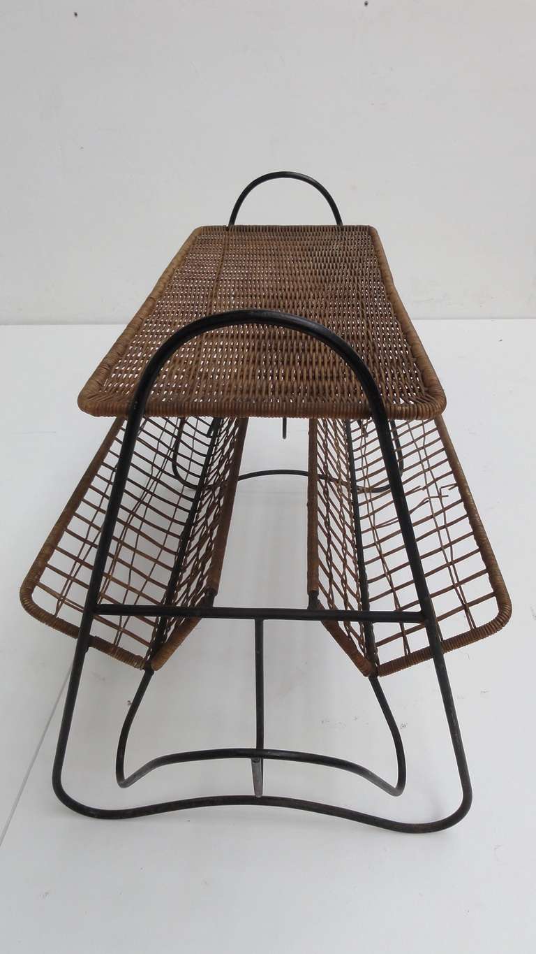 A beautiful French 1950s small side table with magazine rack in black enameled metal rod and original wicker.



Nicely organic shaped and transparent French design in the style of Raoul Guy



There are a few minor damages to the original