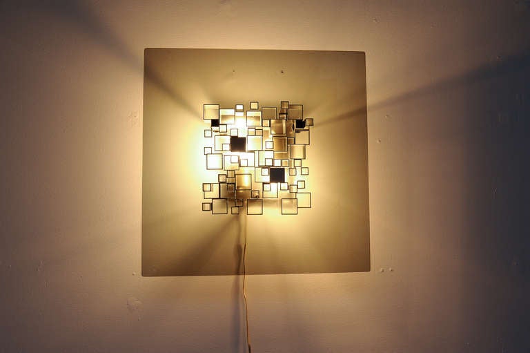 Wonderful illuminated sculpture by master italian lighting designer Angelo Brotto made up from a series of aluminium square section tubes of varying cross section and length illuminated through an acid etched  smoked glass screen diffuser. The