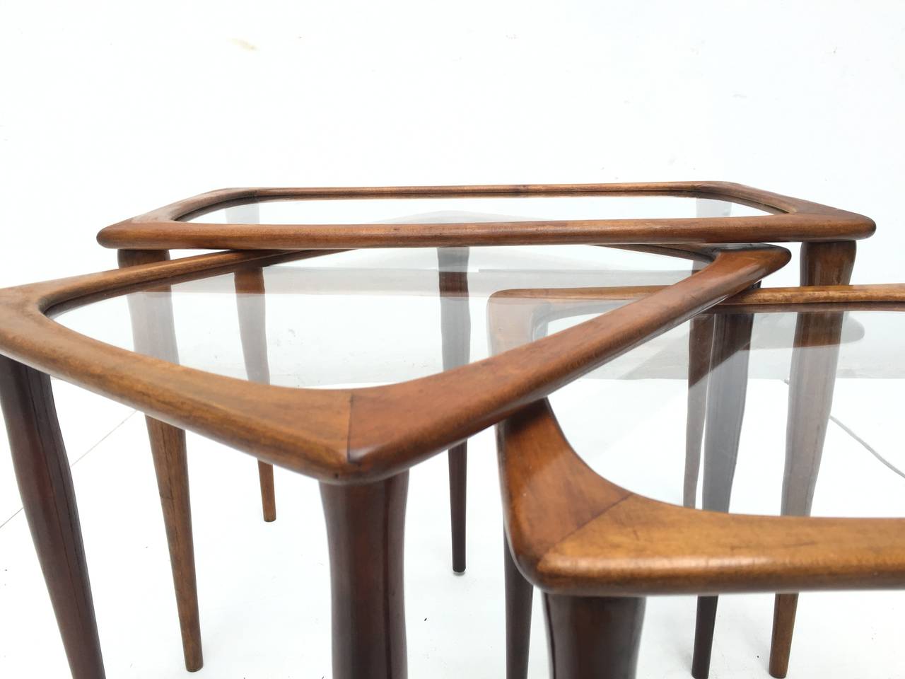 A lovely set of 50's organic Italian design nesting tables in walnut and glass

Strongly attributed to Cesare Lacca for Cassina but we can't  find any published documentation 

For easy shipping the legs can be removed and reveals that the set