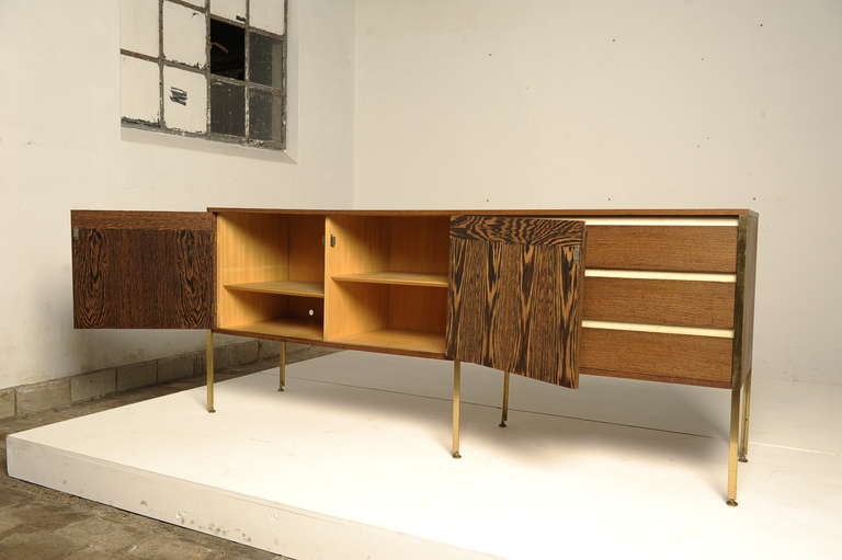 Ultra rare and super elegant piece of Dutch modernism design. This sideboard is designed by Kho Liang Ie & Wim Crouwel for Fristho in the early days, Franeker 1957. This fantastic wenge sideboard has nice details, brass legs, nice white formica