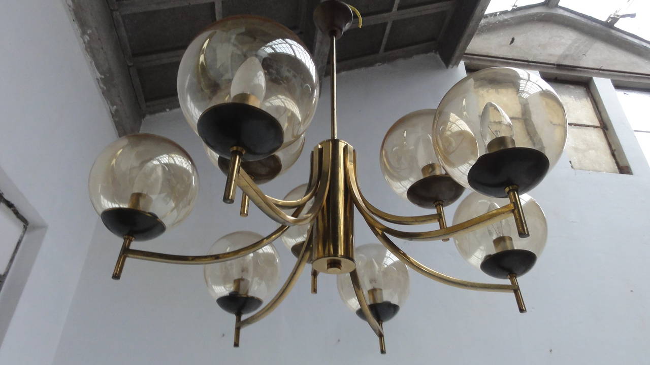 A very nice looking 50's brass Italian chandelier with 9 glass globes with a transparent gold finish