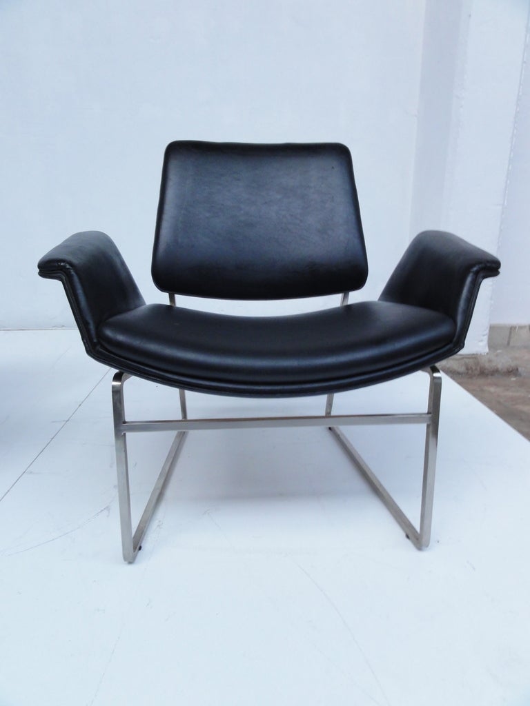 Rare pair of 1960s vintage black leather easy chairs by Illum Wikkelso for Italian manufacturer Arflex. Produced in 1964, this black skai leather upholstered set utilises leather and metal, perfectly demonstrating that simplicity and sleek design is