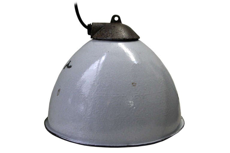 Vintage industrial hanging lamp. Gray enamel with white interior. Cast iron top. Weight | 1.9 kg / 4,2 lb.

All lamps have been made suitable by international standards for incandescent light bulbs, energy-efficient and LED bulbs with an E27
