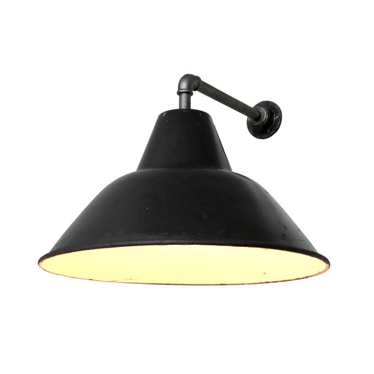Black enamel, cast iron industrial lamp. weight: 1.7 kg.  For use outdoors as well as indoors.  Several pieces in stock.  All lamps have been made suitable by international standards for normal light bulbs, energy-efficient lamps and LED lamps wit