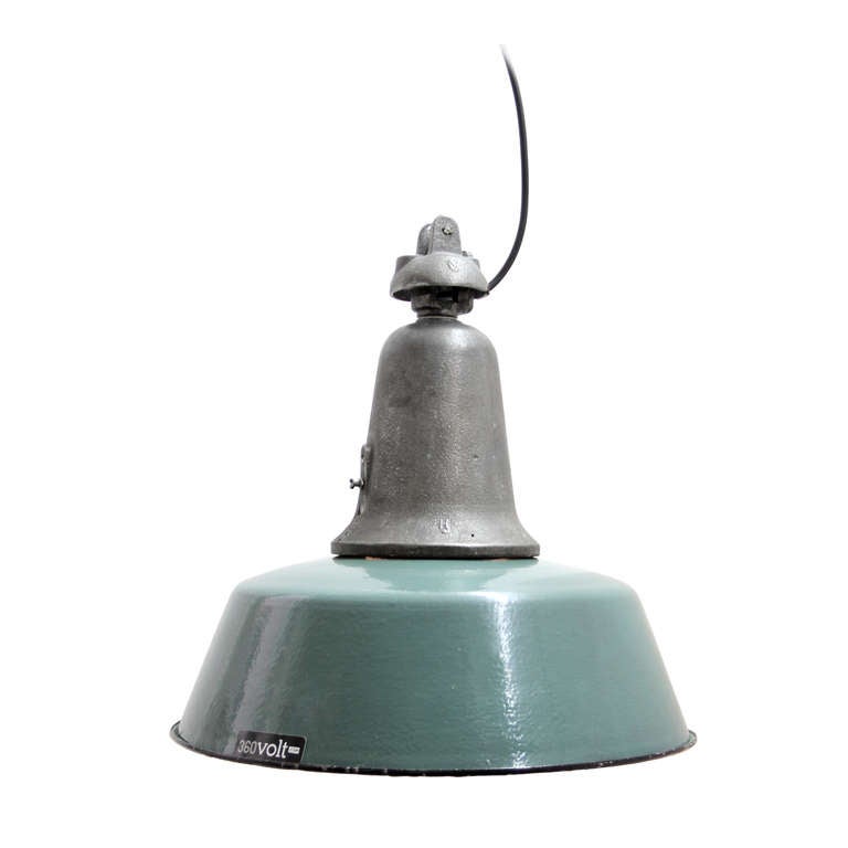 Vintage industrial hanging lamp. Green / Petrol enamel with white interior. Cast iron top. Weight | 5.1 kg / 11.2 lb.

All lamps have been made suitable by international standards for incandescent light bulbs, energy-efficient and LED bulbs with
