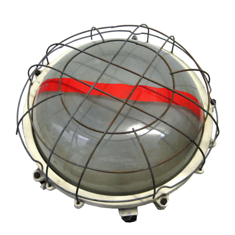 Industrial wall / ceiling scone. Beige cast aluminium. Frosted glass with red bar and iron netting. weight | 7.0 kg / 15.4 lb. 1 piece.

All lamps have been made suitable by international standards for incandescent light bulbs, energy-efficient