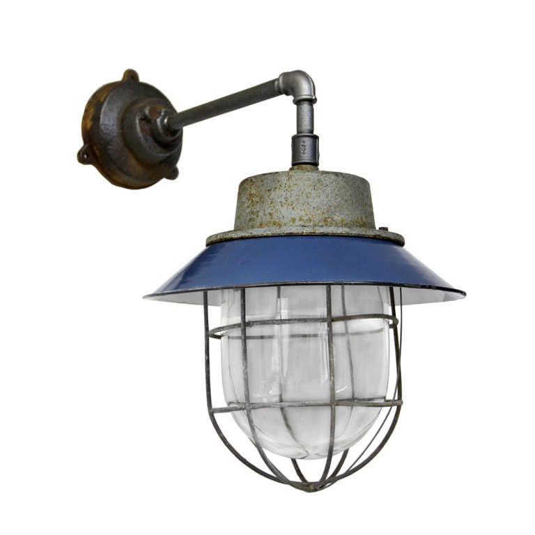 Blue enamel, cast iron industrial lamp. With clear glass. weight: 5.2 kg / 11.5 lb. For use outdoors as well as indoors.

All lamps have been made suitable by international standards for incandescent light bulbs, energy-efficient and LED bulbs