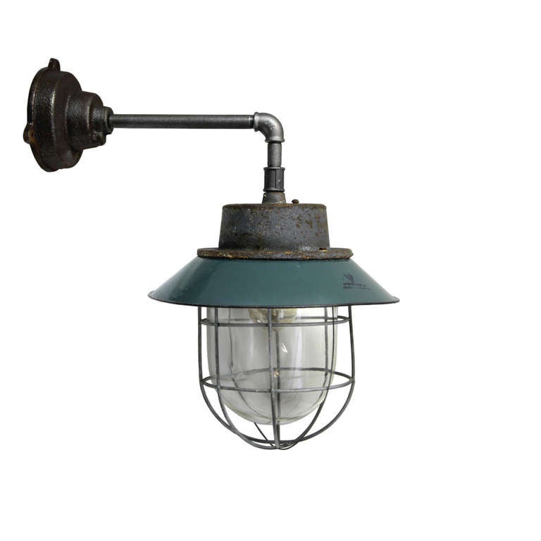 Petrol colored enamel, cast iron industrial lamp. With clear glass. Weight: 6.7 kg or 11.5 lb. For use outdoors as well as indoors.

All lamps have been made suitable by international standards for incandescent light bulbs, energy-efficient and