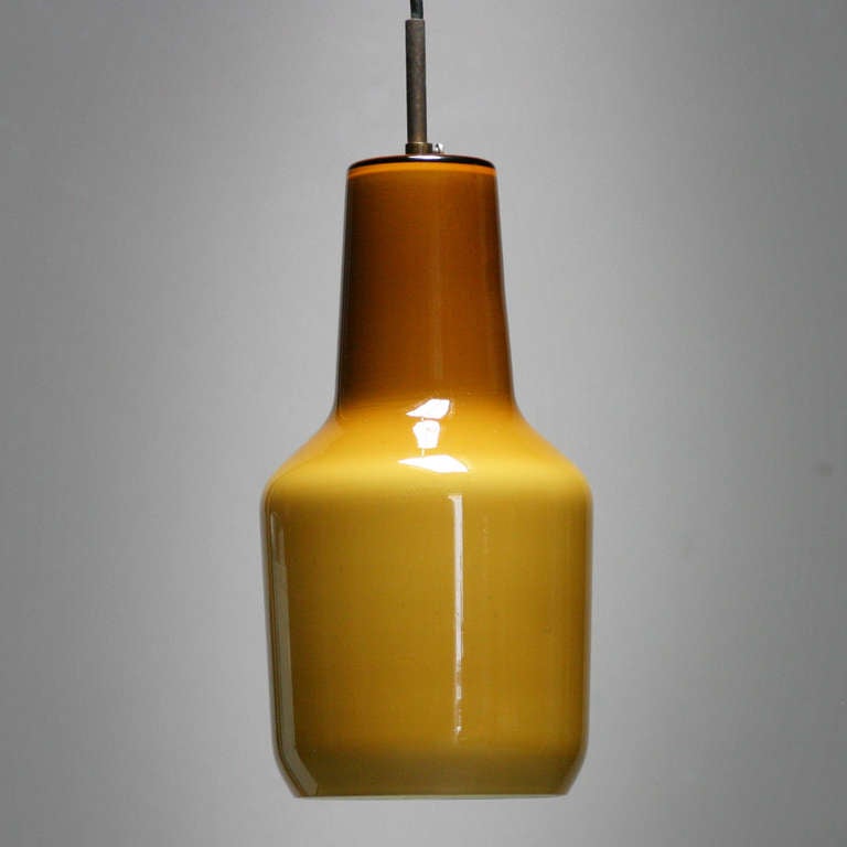 A pendant lamp by Massimo Vignelli for Venini, Italian 1950’s.
Height: 12 in. (30,5 cm), diameter: 6.3 in.  (16 cm).
We can offer you also a white and an amber 'Fungo' table light by Vignelli.

Though the achievements of the Italian born