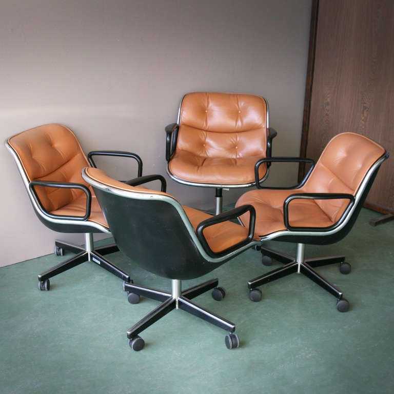 Four brown leather Charles Pollock office chairs for Knoll International.
Fibreglass shell with chromed, extruded aluminium rim holding leather covered upholstery on swivelling aluminium base with castors. Design 1963.