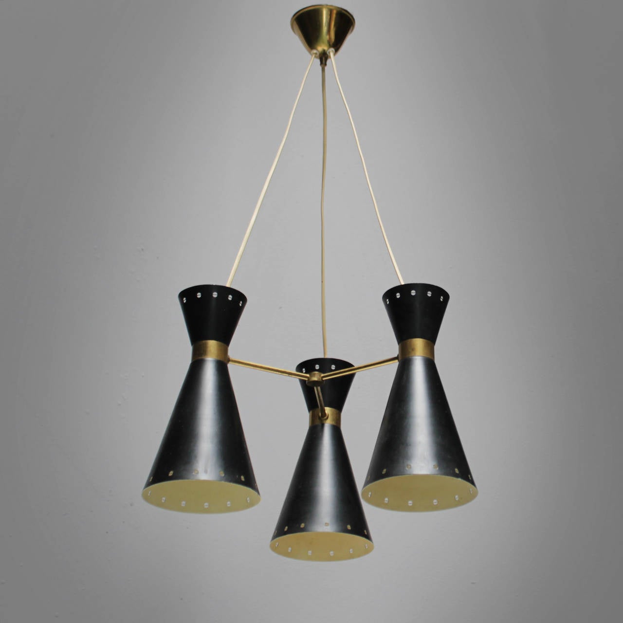 Swedish diabolo chandelier with three lights and a brass canopy. Black lacquered metal with brass connections.
Total height from ceiling till drop: 30.1 in. (78 cm), total diameter 14.9 in. (38 cm). Height of a light: 11.0 in. (28 cm), diameter of