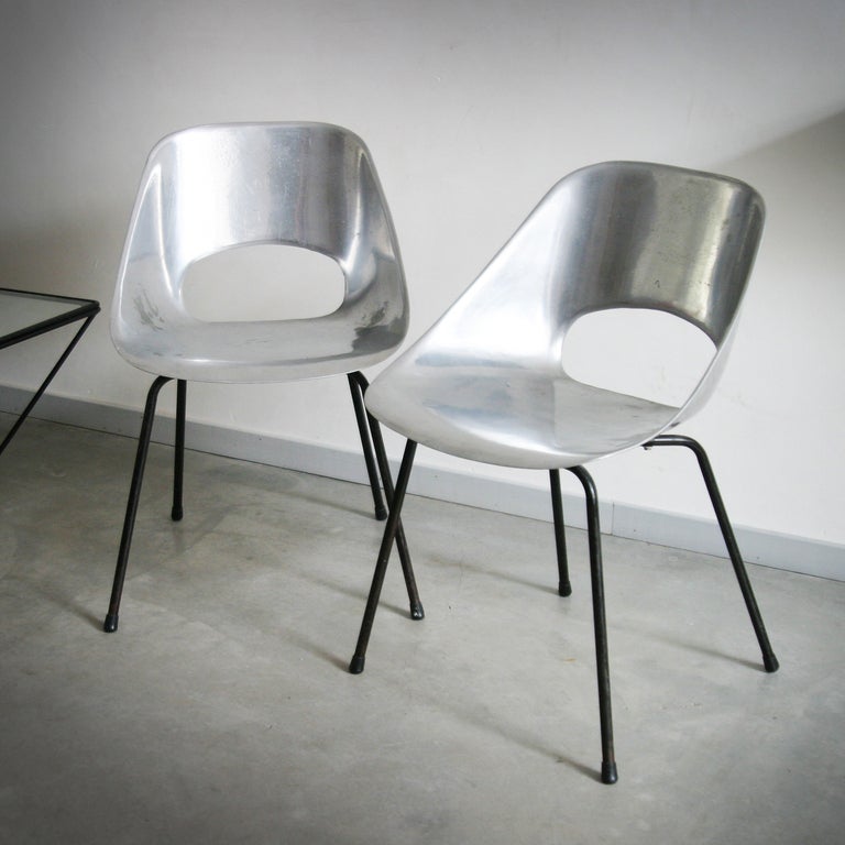 Two aluminum chairs 'Tulipe' by Pierre Guariche for Steiner France. 
Seating cast aluminum shell resting on a tubular metal base lacquered black. One chair has some oxidation stains but they have a nice patina and are also in a good