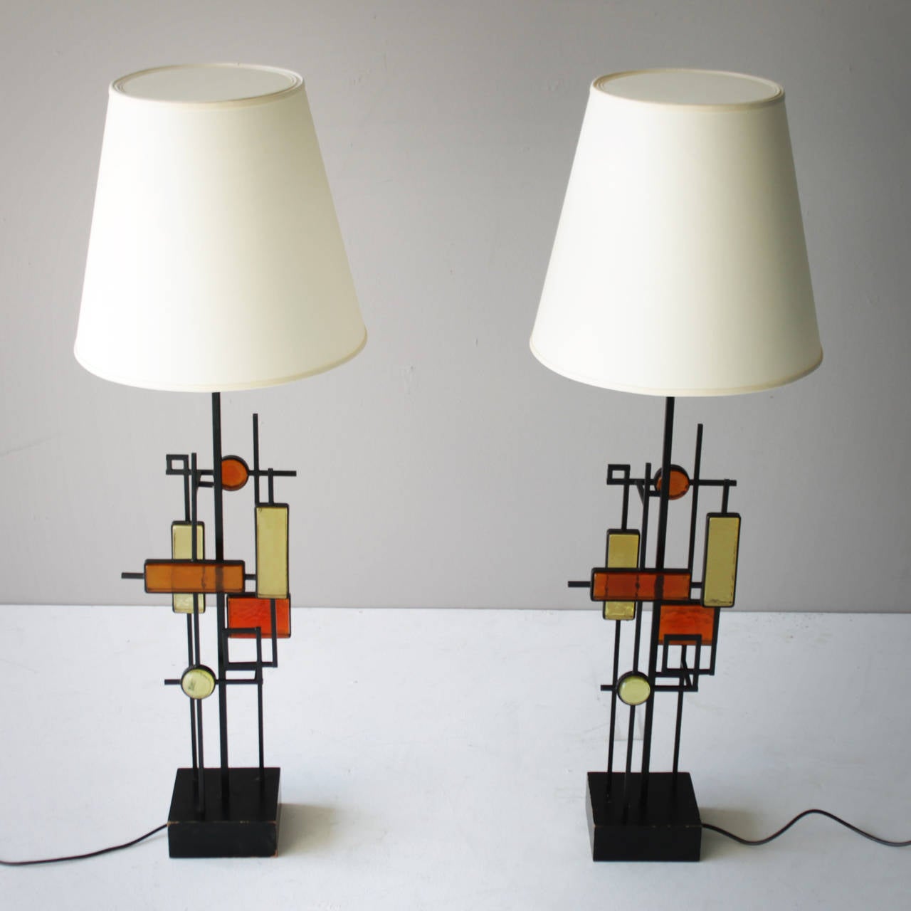 A pair of large glass geometric shaped lamps by Svend Aage Holm Sorensen for Holm Sorensen and Co. Made in Denmark. Marked. Shades have been renewed.
Measurements: Width: 8.2 in. (21 cm), height: 31.5 in. (80 cm), total height with shade: 39.3 in.