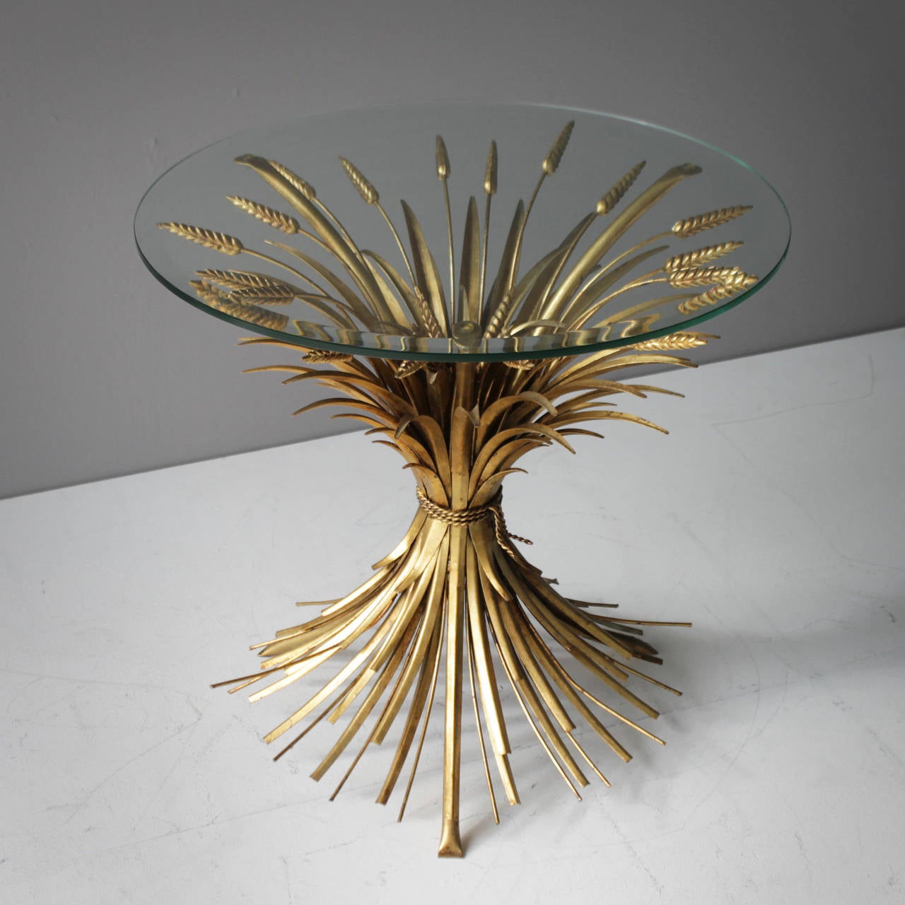 Side or end table, style of Coco Chanel. Beautiful detailed with gold leaf finish and a faceted top. Very good condition.