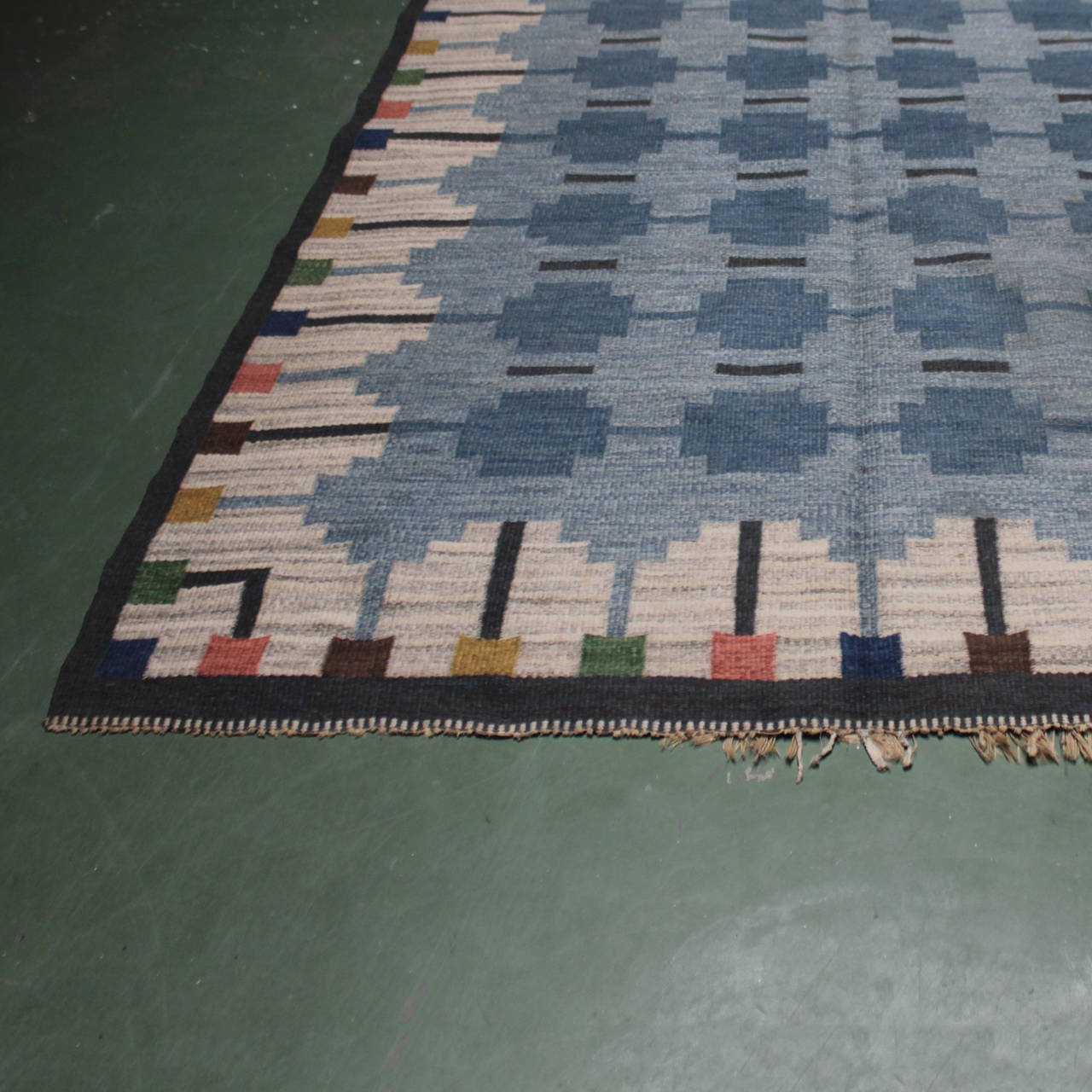 Vintage Swedish woolen flat-weave 'Kilim' signed by Ingegerd Silow (1916-2005). Measurements: 116.9 in. x 79.1 inches (297 cm x 201 cm). Woven initials. Wear of age at the fringe. This rug is never washed or cleaned, some small spots, maybe rust