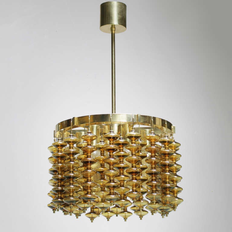 Large chandelier by Hans-Agne Jakobsson for Markaryd Sweden. Marked with a label.
Consisting thirty six strands of amber colored glass discs. Beautiful condition.
Six light bulbs.
Measurements: a strand is 13.3 inches (34 cm). Diameter: 20.8 in.