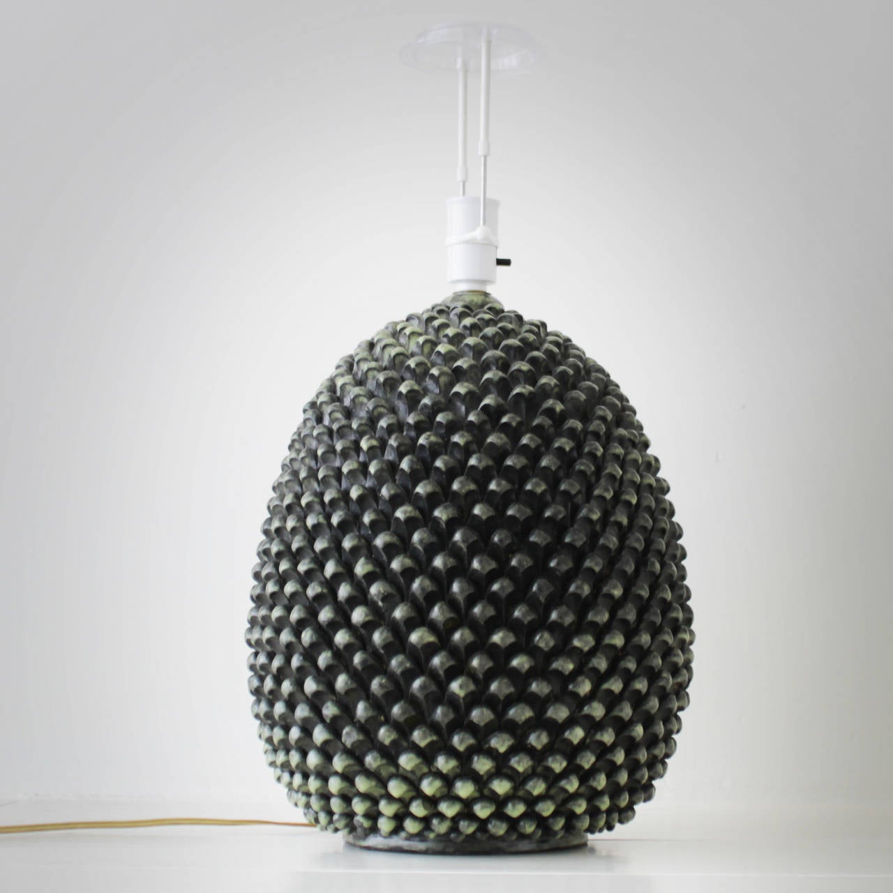 Pine cone table lamp by Marcello Fantoni for Fantoni Studio Firenze, Italy.
Ceramic lamp in deep green glaze colors. Signed.
Diameter: 11.8 inches (30 cm), height including the socket 18.9 in. (48 cm).
We offer this lamp without the shade.