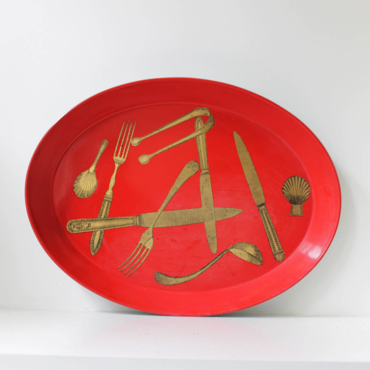 Enameled tray in red and gold, designed by Piero Fornasetti, Milano (1913-1988). Marked at the back with a label.