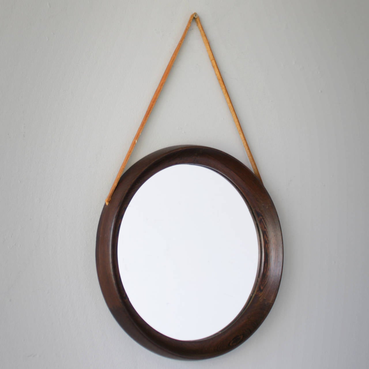 Wenge framed mirror with leather strap, attributed to Uno & Osten Kristiansson. Nice decorative mirror executed in wenge, an exquisite type of wood which is far less common than a teak or rosewood frame.
Good condition except the leather strap,