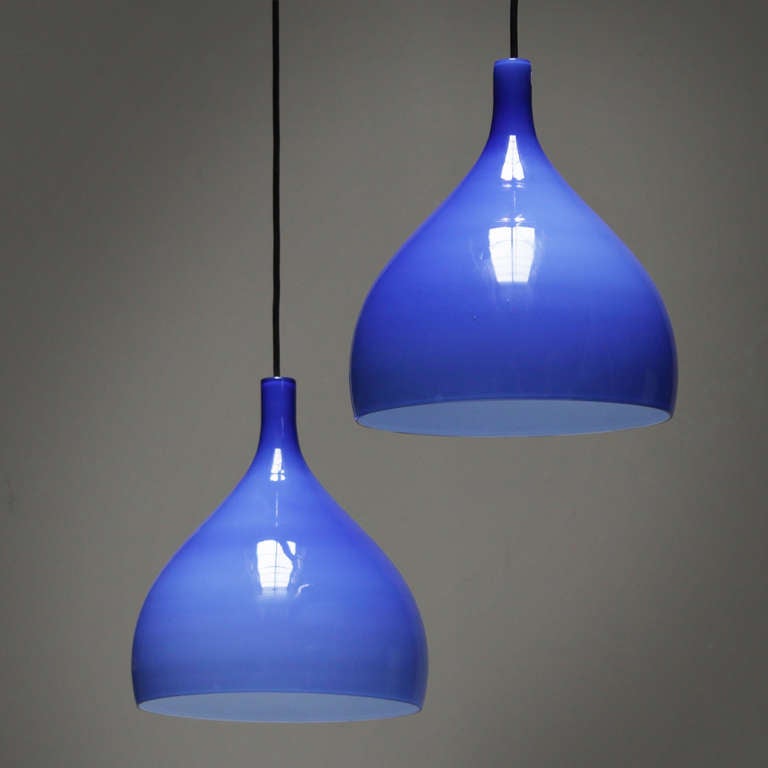 Pair of blue Italian pendants by Venini Murano, mounted on a black bar. Blue glass with a layer of white glass on the inside.