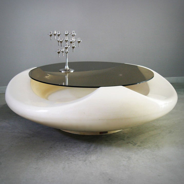 Round white fiberglass coffee table with smoked glass.