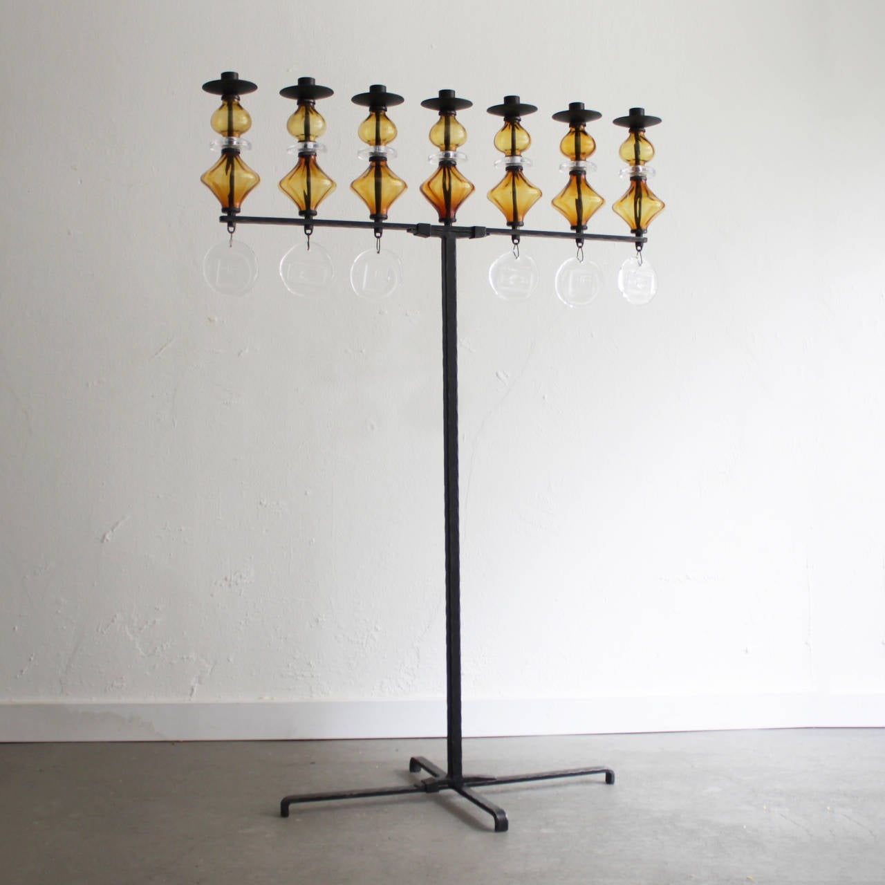 Large candleholder by Erik Hoglund, Sweden. Wrought iron and glass. Clear and amber mouth blown glass by Boda Nova Glassworks and the iron work was done at Axel Stromberg Ironworks.